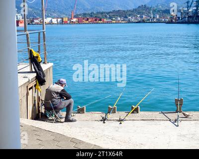 Batumi, Georgia. 10.14.2023 Fishermen in the port of Batumi. Waiting for a peck. People on vacation. Hobbies for people. Day off at the port. Fish cat Stock Photo