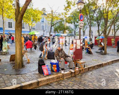 Artists at work painting and displaying pictures for sale in Place du Tertre, Montmartre, 18th arrondissement, Paris, France Stock Photo