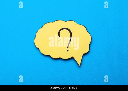 Paper speech bubble with question mark on light blue background, top view Stock Photo