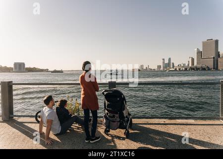 usa, ny - sep 12th 2022 people in New York city Manhattan skyline seen from Brooklyn waterfront . High quality photo Stock Photo