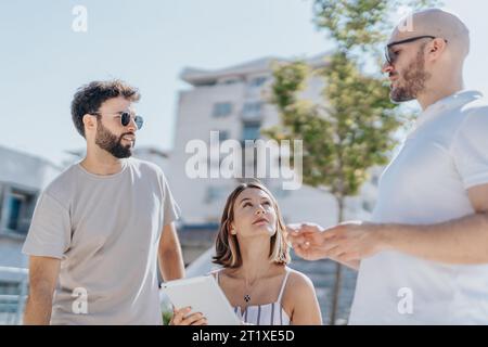Successful Architectural Team Analyzing and Collaborating on Modern Infrastructure Project in City Stock Photo