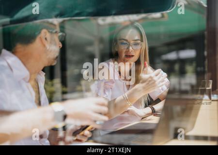 Successful Business Partners Discussing Project Instructions in Corporate Office Stock Photo