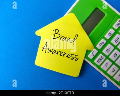 Top view calculator and colored sticky notes with the word Brand Awareness Stock Photo