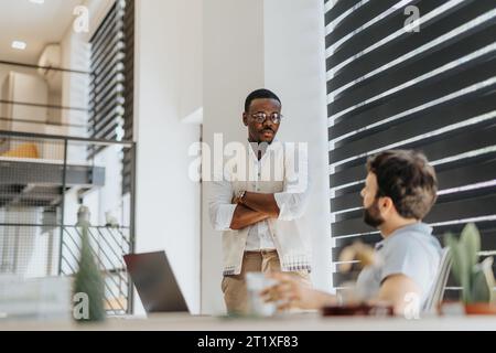 Concentrated multiracial colleagues working on project together at the office. Teamwork concept. Stock Photo