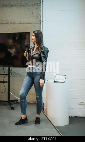 Middle-aged female business coach delivering lecture at business company. Stock Photo