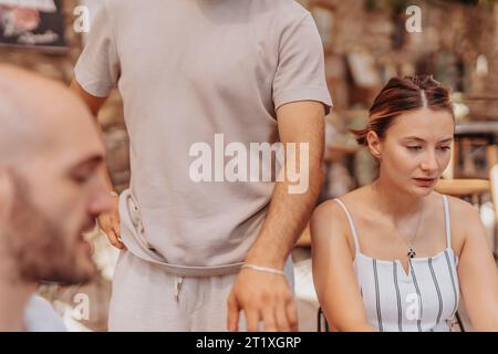A group of experts discussing e-commerce strategies and trends while working in a vibrant cafe bar. Stock Photo