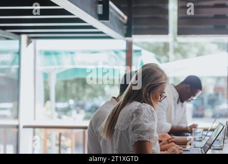 Diverse, efficient team in a creative office. Analyzing reports, planning projects, and using technology for successful business growth. Stock Photo