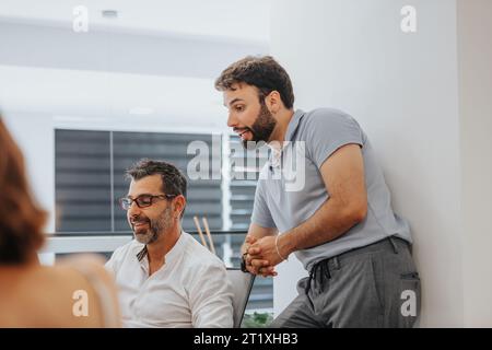 Diverse group of confident coworkers in a creative office, analyzing reports, conducting market research, and creating a strategic plan for success. Stock Photo
