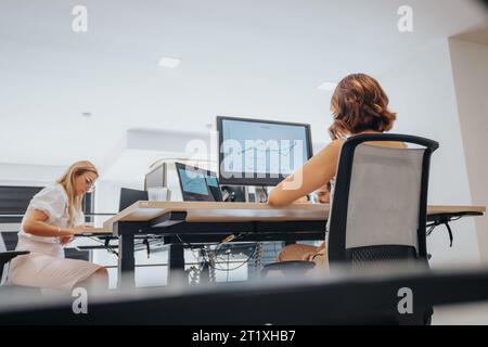 Analyzing Reports with Confident Business People in a Creative Office Stock Photo