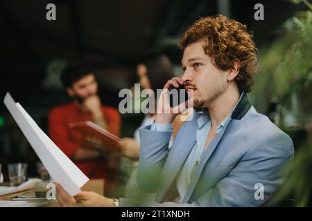 Collaborative Planning: Architects, Engineers, and Executives Discussing Blueprint at Coffee Bar Stock Photo