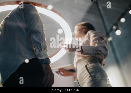 Two businesspeople discussing work outcomes, project costs, and a start-up plan. Collaboration, teamwork, and successful growth are key in business. Stock Photo