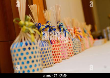 Handmade woven bamboo basket tie colorful ribbons as a gift on various occasions Stock Photo