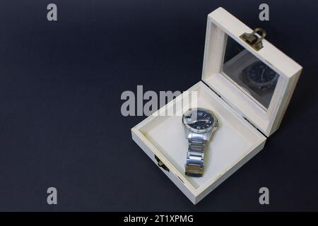 watch in wooden box Small empty light brown wooden box, split latch, open container on black background cut out. Small handicrafts, bags, decorations, Stock Photo