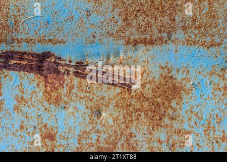 Blue rusted metal background. A rusty and scratched painted metal wall. Rusty metal background with streaks of rust Stock Photo