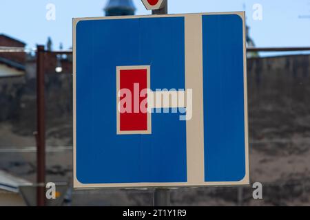 Road sign exit to a dead end. Blue road sign on a wooden post in a rural area. Stock Photo