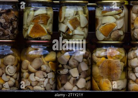 The preserve mushrooms. Delicious marinated white mushrooms in the glass jars. Homemade preservation in autumn. Stock Photo