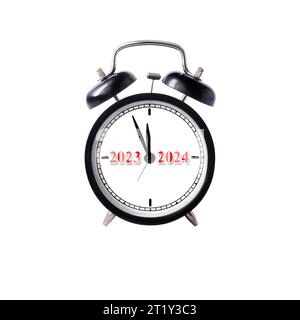 A classic alarm clock with 2023-2024 inscriptions on the dial. New Year concept. Stock Photo