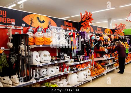 Interior of Sainsburys in Pinhoe Exeter  - view of Halloween products on shelf with shop worker for Autumn 20923 Stock Photo
