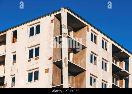 Unfinished condominium apartment building with rigid polystyrene foam board insulation glued to exterior wall, low angle view Stock Photo