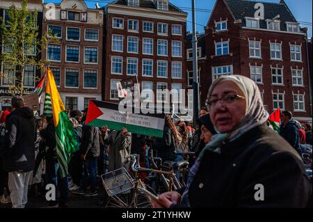 October 15th, Amsterdam. The Palestinian community in The Netherlands organized a march in the center of the city to condemn the government of Israel and express solidarity with the Palestinian people. During the rally, around 10,000 demonstrators waved Palestinian flags and carried banners, sending a powerful message of solidarity with Gaza and the Palestinian people. Stock Photo
