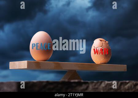 Two eggs on the scales, one whole and the other broken against the background of a dark sky, a concept on the theme of the balance between peace and w Stock Photo