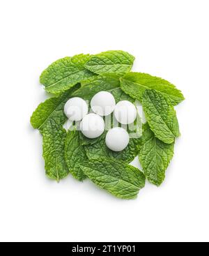 Mint candies. Menthol bonbons and mint leaves isolated on the white background. Stock Photo