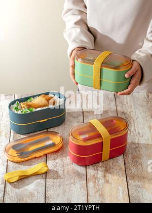 https://l450v.alamy.com/450v/2t1ypth/a-girl-holds-a-lunch-box-in-her-hands-lunch-box-for-school-lun-2t1ypth.jpg