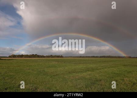 Double rainbow over monotone grassland Stock Photo