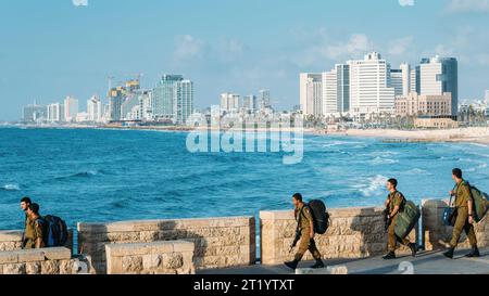 Tel Aviv, Israel - March 3rd, 2017: Soldiers of the Israeli Defense Forces march overlooking the Tel Aviv, Israel skyline Stock Photo