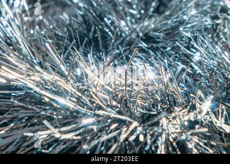 Close up of a silver tinsel garland. Christmas ornament. Abstract background Stock Photo