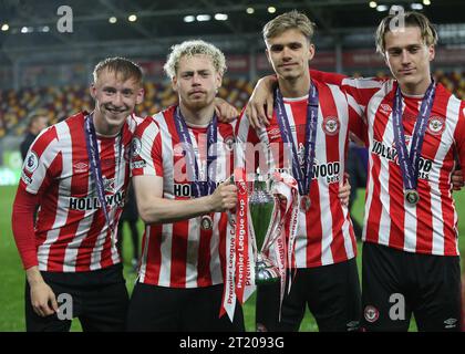 Max Dickov, Nathan Young-Coombes, Romeo Beckham of Brentford B hold aloft The Premier League Cup 2023 after the 2-0 win against Blackburn Rovers U21. - Brentford B v Blackburn Rovers U21, Premier League Cup Final 2023, GTECH Community Stadium, London, UK - 9th May 2023. Editorial Use Only - DataCo restrictions apply Stock Photo