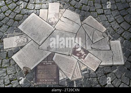 Munich, Germany. 16th Oct, 2023. In front of the entrance to the main building of the Ludwig-Maximilians-Universität (LMU) at Geschwister-Scholl-Platz, the leaflets of the resistance group 'White Rose' are embedded in the ground as a memorial. It commemorates Sophie and Hans Scholl. The siblings had been arrested on February 18, 1943 while distributing leaflets against the Nazi regime and executed four days later. Credit: Peter Kneffel/dpa/Alamy Live News Stock Photo