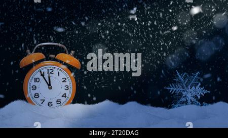 abstract Christmas and New Year concept with christmas decorations, snow, alarm clock snowflakes and stars on black background Stock Photo