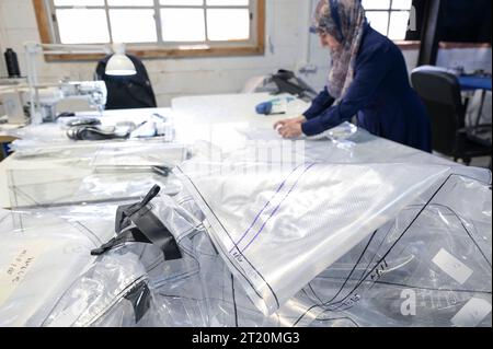 Israel, biogas ISRAEL, Bet Yanay, HomeBiogas LTD, production and distribution of small home biogas kits, foil cutting by palestinian worker Beit Yanai Israel Stock Photo