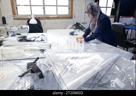 Israel, biogas ISRAEL, Bet Yanay, HomeBiogas LTD, production and distribution of small home biogas kits, foil cutting by palestinian worker Beit Yanai Israel Stock Photo