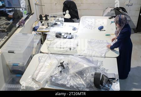 Israel, biogas ISRAEL, Bet Yanay, HomeBiogas LTD, production and distribution of small home biogas kits, foil cutting by palestinian worker Beit Yanai Israel Stock Photo