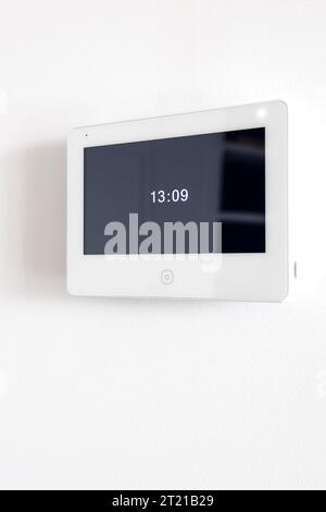 A white video intercom screen on a white apartment wall Stock Photo