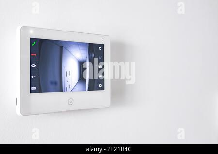 A white video intercom screen on a white apartment wall Stock Photo