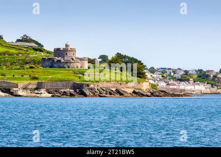 24 May 2023: St Mawes, Cornwall, UK - St Mawes Castle and the popular village of St Mawes, from the water. Built by Henry VIII to defend against Frenc Stock Photo