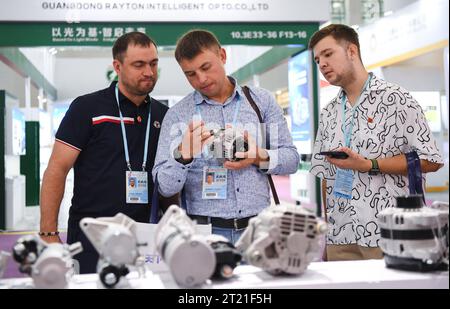 (231016) -- GUANGZHOU, Oct. 16, 2023 (Xinhua) -- Russian buyers learn about vehicle components at the 134th session of the China Import and Export Fair in Guangzhou, south China's Guangdong Province, Oct. 15, 2023. The 134th session of the China Import and Export Fair, also known as the Canton Fair, has attracted exhibitors and buyers from across the globe. About 60 percent of the exhibitors attending the import exhibition are Belt and Road Initiative (BRI) partner countries, and the number of buyers from BRI partner countries has witnessed an increase of 11.2 percent compared with last sessio Stock Photo