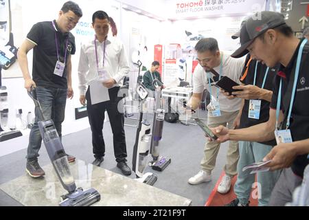 (231016) -- GUANGZHOU, Oct. 16, 2023 (Xinhua) -- Participants from Vietnam visit a booth for cleaning machines at the 134th session of the China Import and Export Fair in Guangzhou, south China's Guangdong Province, Oct. 15, 2023. The 134th session of the China Import and Export Fair, also known as the Canton Fair, has attracted exhibitors and buyers from across the globe. About 60 percent of the exhibitors attending the import exhibition are Belt and Road Initiative (BRI) partner countries, and the number of buyers from BRI partner countries has witnessed an increase of 11.2 percent compared Stock Photo