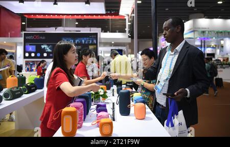 (231016) -- GUANGZHOU, Oct. 16, 2023 (Xinhua) -- A Sudanese buyer negotiates business at a booth for smart speakers at the 134th session of the China Import and Export Fair in Guangzhou, south China's Guangdong Province, Oct. 15, 2023. The 134th session of the China Import and Export Fair, also known as the Canton Fair, has attracted exhibitors and buyers from across the globe. About 60 percent of the exhibitors attending the import exhibition are Belt and Road Initiative (BRI) partner countries, and the number of buyers from BRI partner countries has witnessed an increase of 11.2 percent comp Stock Photo