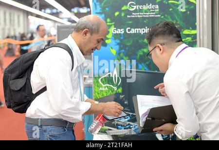 (231016) -- GUANGZHOU, Oct. 16, 2023 (Xinhua) -- A buyer from Egypt visits a booth for kitchen wares at the 134th session of the China Import and Export Fair in Guangzhou, south China's Guangdong Province, Oct. 15, 2023. The 134th session of the China Import and Export Fair, also known as the Canton Fair, has attracted exhibitors and buyers from across the globe. About 60 percent of the exhibitors attending the import exhibition are Belt and Road Initiative (BRI) partner countries, and the number of buyers from BRI partner countries has witnessed an increase of 11.2 percent compared with last Stock Photo