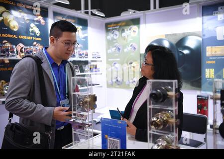 (231016) -- GUANGZHOU, Oct. 16, 2023 (Xinhua) -- An exhibitor (R) from Thailand negotiates business with a visitor at the 134th session of the China Import and Export Fair in Guangzhou, south China's Guangdong Province, Oct. 16, 2023. The 134th session of the China Import and Export Fair, also known as the Canton Fair, has attracted exhibitors and buyers from across the globe. About 60 percent of the exhibitors attending the import exhibition are Belt and Road Initiative (BRI) partner countries, and the number of buyers from BRI partner countries has witnessed an increase of 11.2 percent compa Stock Photo