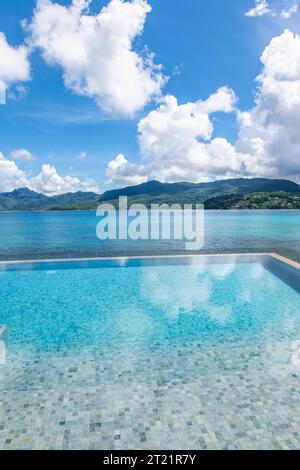 Infinity pool with sea view on tropical Island. Stock Photo