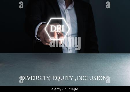 Man in suit using virtual touchscreen with the letters D ,E ,I , diversity equity Inclusion , concept , copy space . Stock Photo