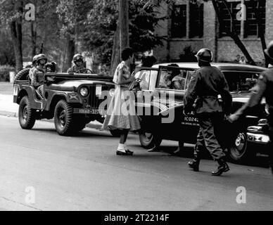 101st Airborne Division soldiers of the U.S. Army escort African American students, who would become known as the Little Rock Nine, into Central High School in Little Rock, Arkansas, in September 1957 amidst extreme resistance to integration by Arkansas Governor Orval Faubus who activated the Arkansas National Guard to block any integration efforts. The U.S. Army response, initiated by President Dwight Eisenhower, was called Operation Arkansas. Stock Photo