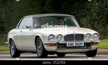 Bicester,Oxon.,UK - Oct 8th 2023: 1976 white Daimler Double Six  classic car driving on an English country road. Stock Photo