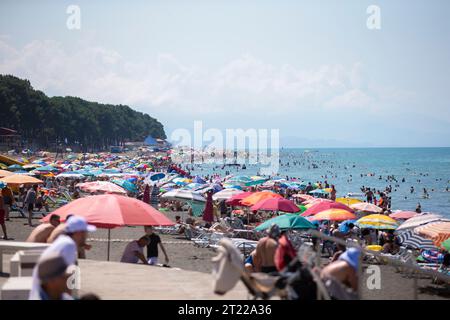 August 6, 2022. Georgia. Ureki village. Central beach with magnetic black sand. Huge number of people on the beach. Stock Photo