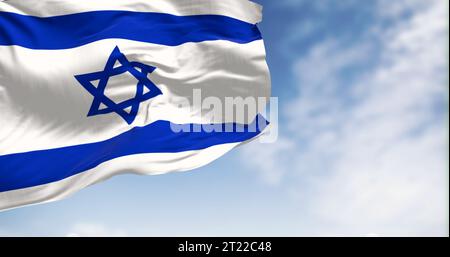 State of Israel national flag waving in the wind on a clear day. Blue Star of David in the center, flanked by two horizontal blue stripes on a white f Stock Photo